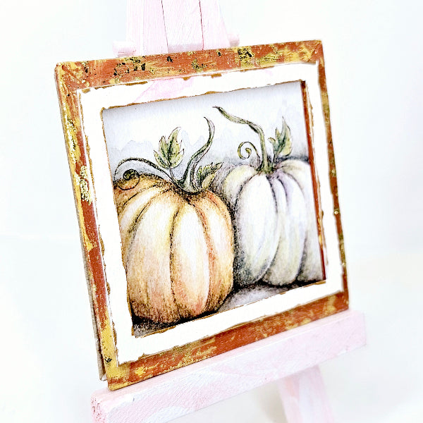 Framed artwork of pumpkins on a white background